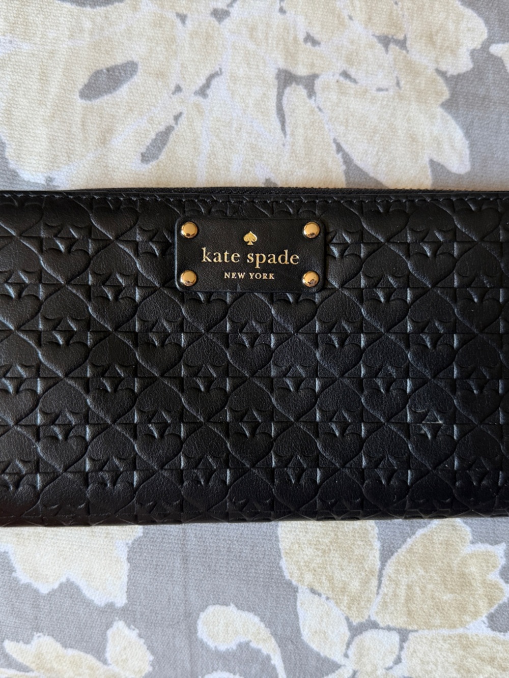 kate spade black embossed zip-around wallet with gold plaque